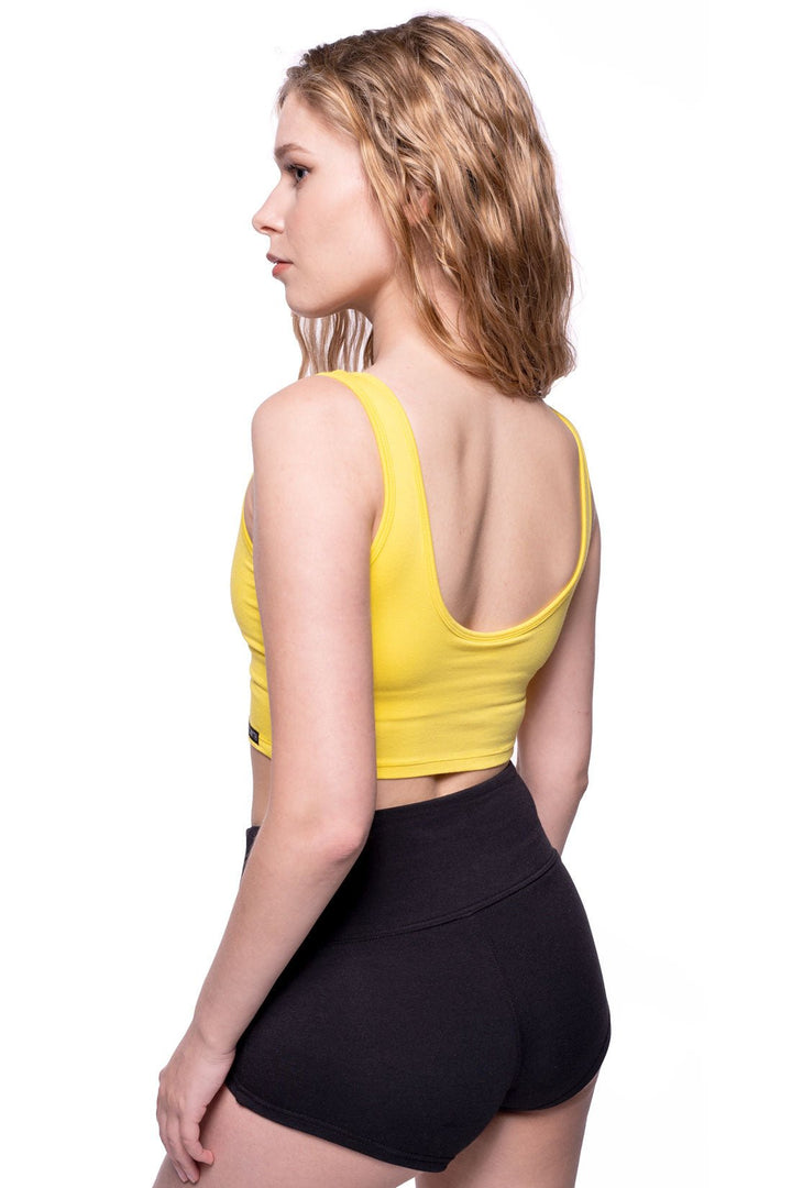 Yellow scoop back sports bra and black bamboo booty shorts